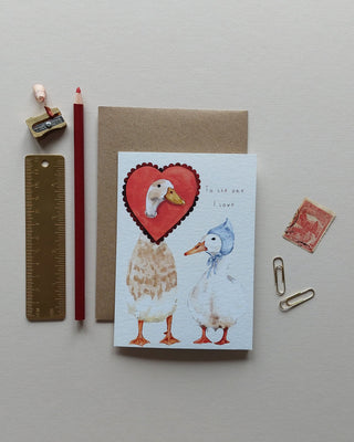 To the one I love text surrounded by two hand painted whimsical ducks, one wearing a baby blue bonnet and one indian runner duck wearing a scalloped edge red heart around its neck 