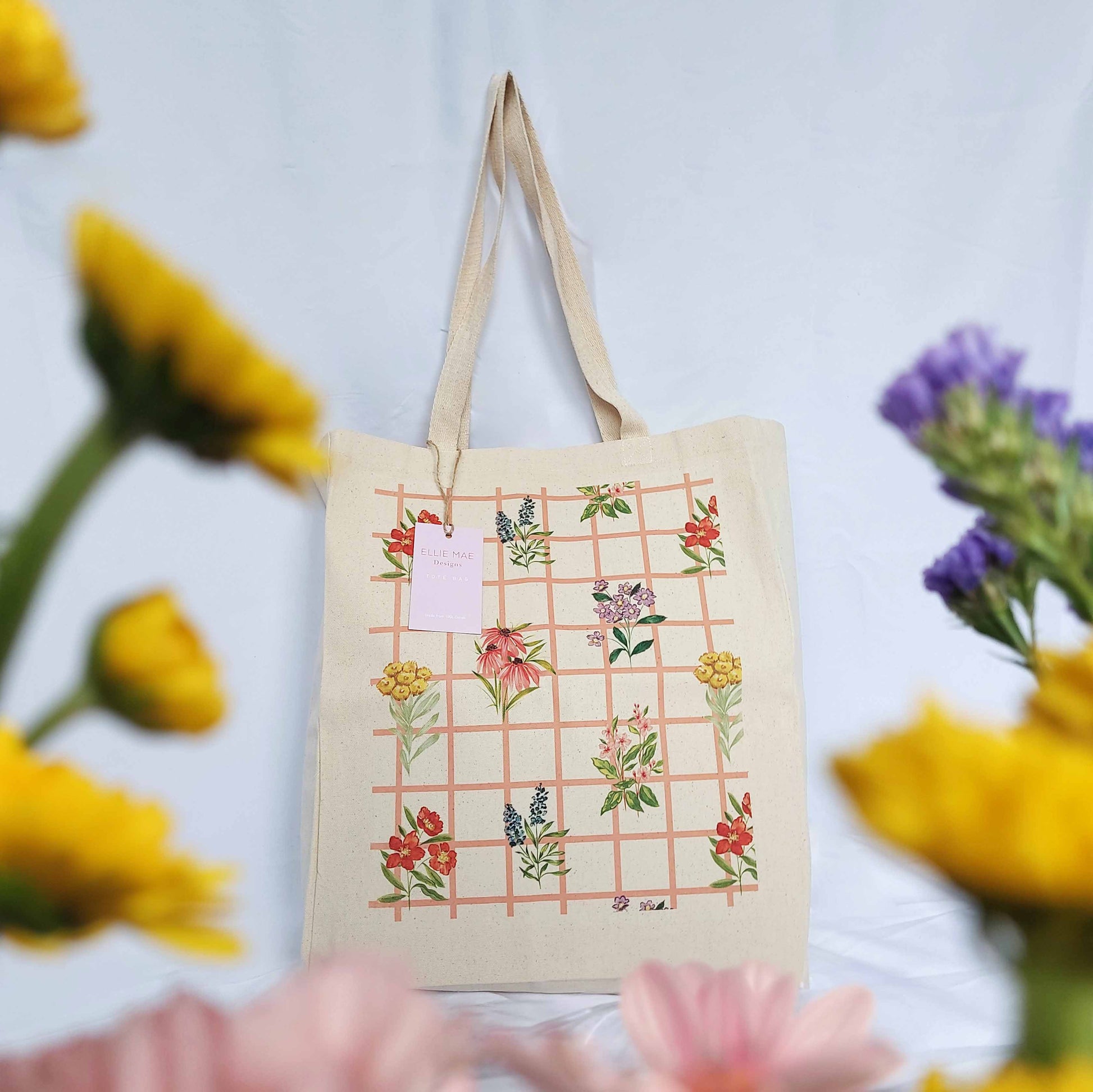 big canvas tote bag with comfortable woven webb straps featuring colourful floral gridded wildflower pattern