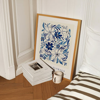 blue inky floral art print styled on bedroom floor with fashion lifestyle books 