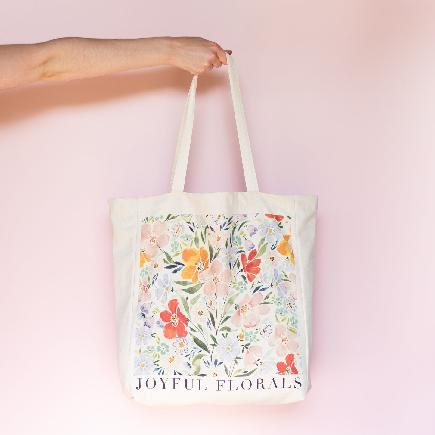 joyful florals tote bag. Gusset Tote Bag with an a5 inner pocket. Colourful wildflower design on the front with the text joyful florals. Originally hand painted by ellie mae.