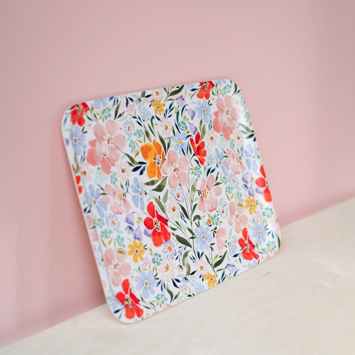 joyful florals tray against pink and wood back drop