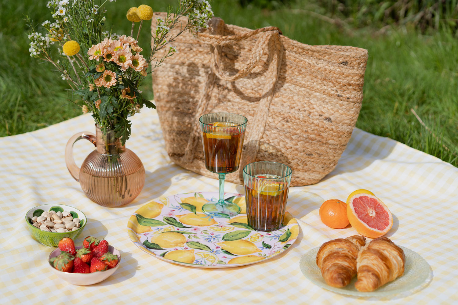 Circular lemon patterned serving tray on a picnic inspired set up. 