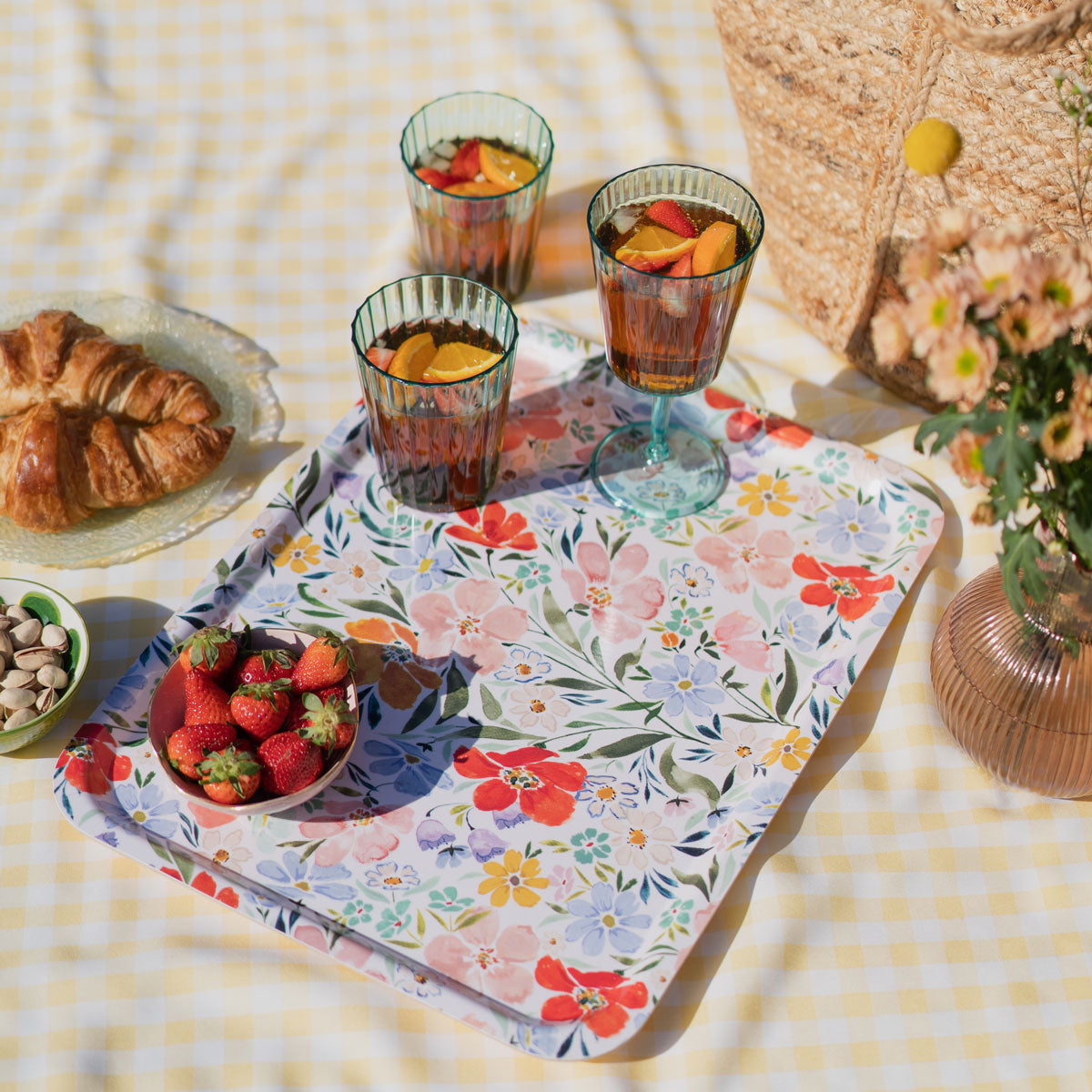 floral picnic tray flatlay, tray holding strawberries in a dish and glasses of fresh juice