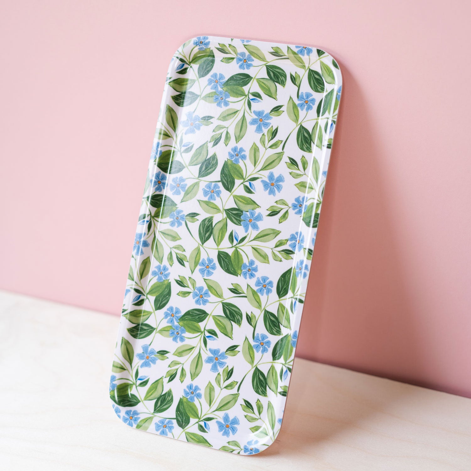 blue floral tray against a pink and wooden back drop