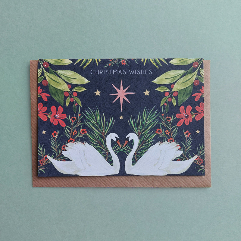 hand painted design of swans, christmas berries, festive foliage christmas card